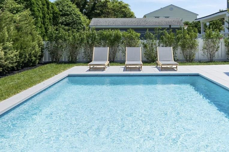 Crystal clear residential swimming pool with clean blue water after professional pool maintenance