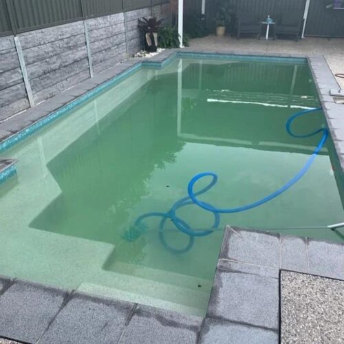 Cloudy residential swimming pool that needs professional cleaning