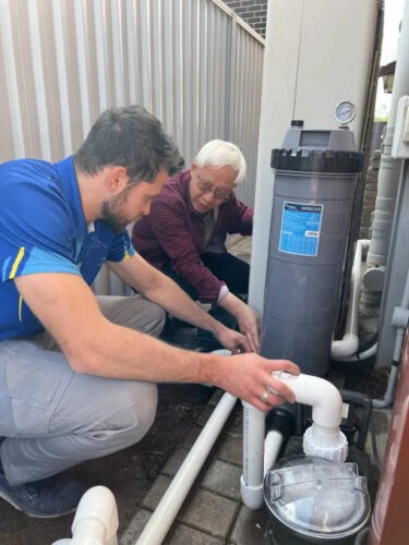 Technician installing a pool pump in Melbourne